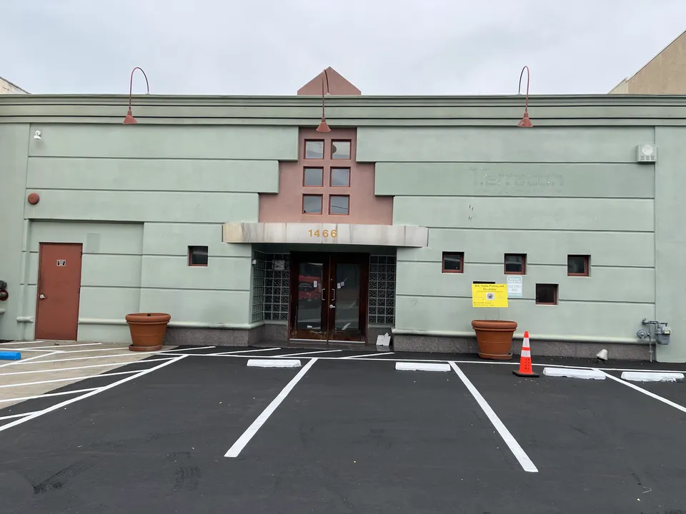 Commercial building exterior after a full repaint of walls and trim.