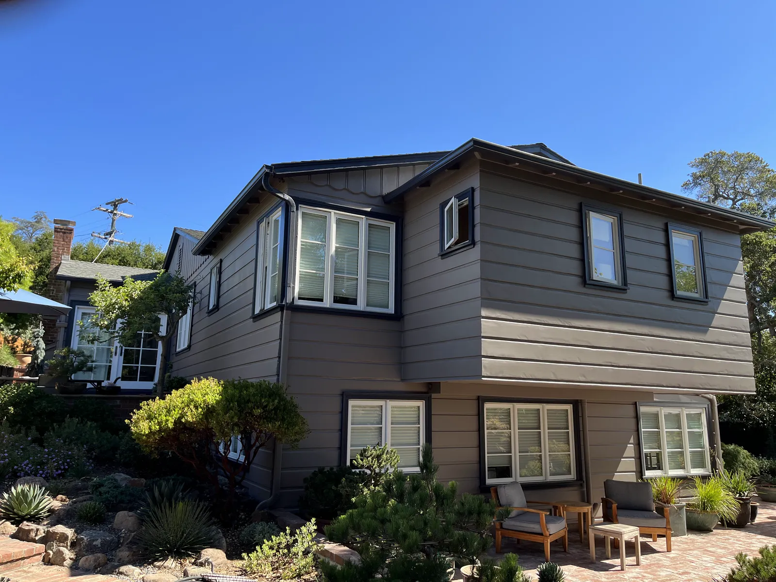 Two-story Oakland hills home freshly repainted, with crisp white trim and a new front porch finish.