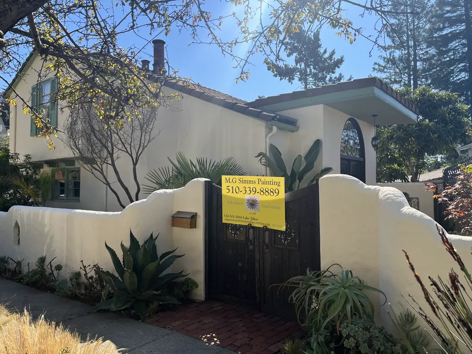 Spanish-style stucco home with newly painted walls, trim and window ironwork.