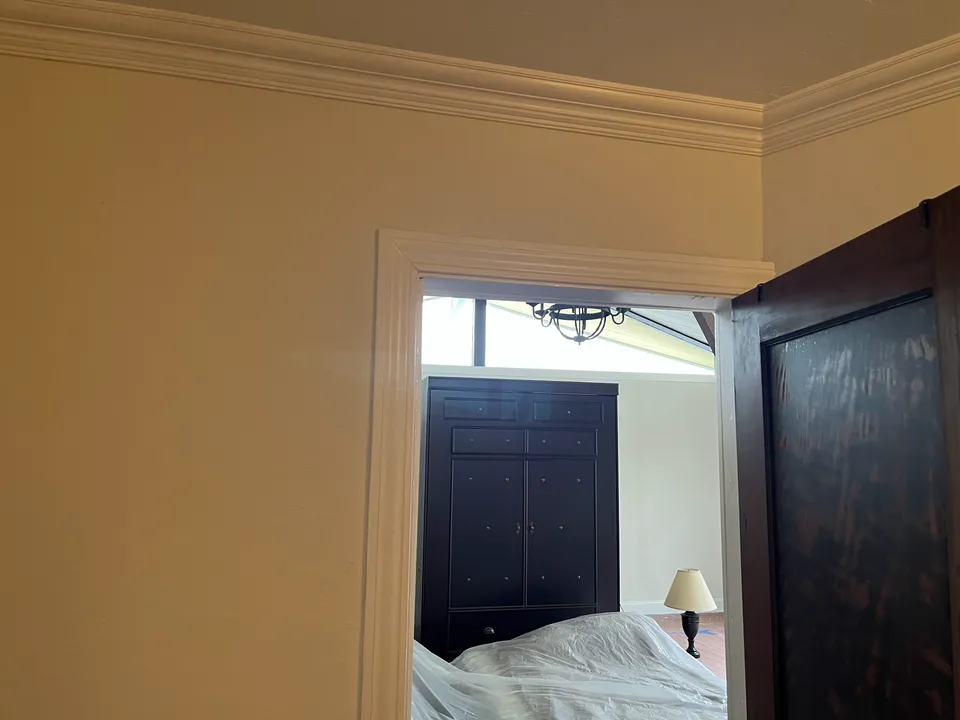 Interior hallway with crisply painted walls, white door casings and baseboard molding.