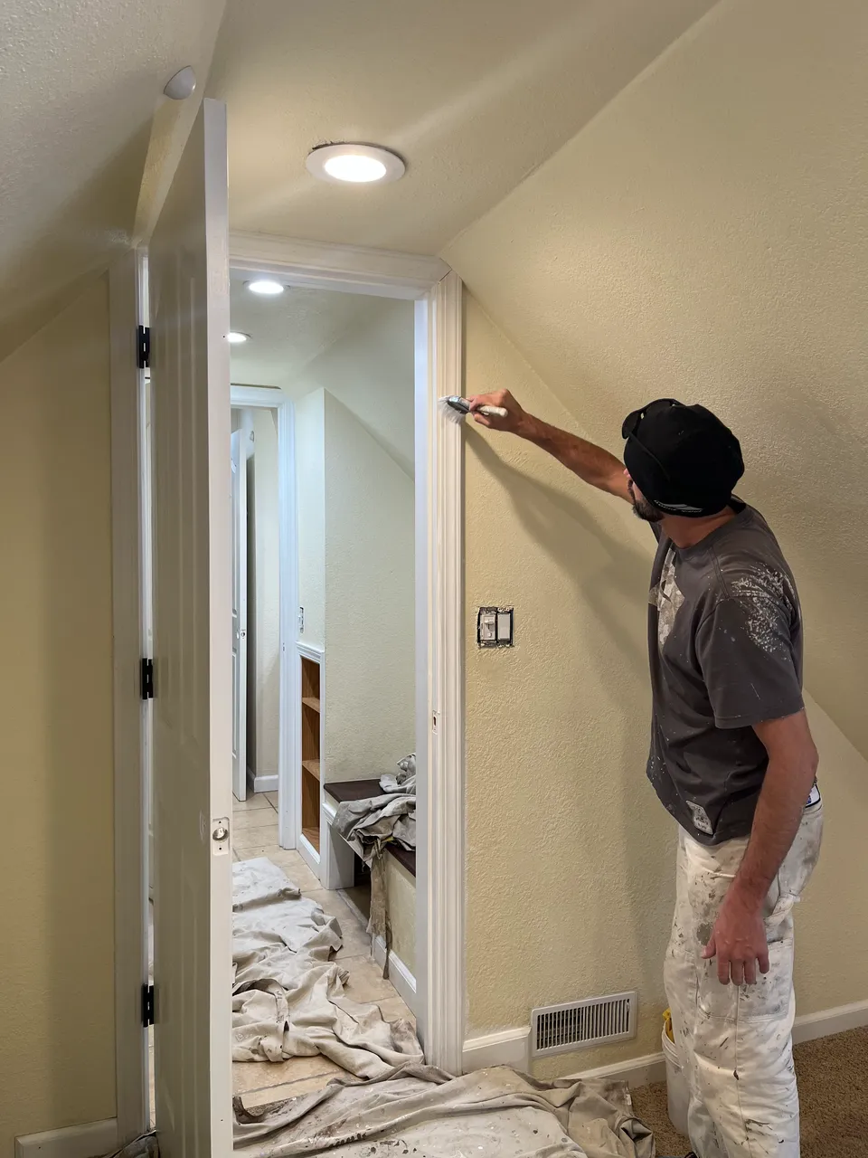M.G. Simms painter rolling a fresh coat onto an interior wall.